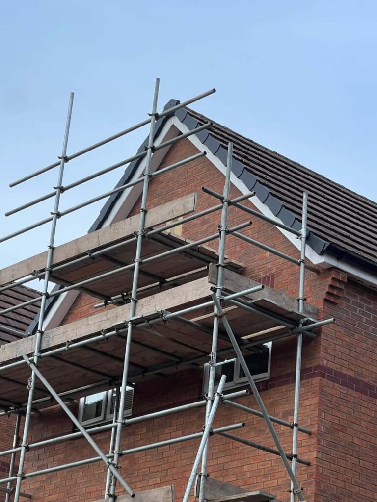 This is a photo of a roof which has just been repaired. There is a scaffold located at the gable end for access onto the roof. Works carried out by LJ Roofing Criklade